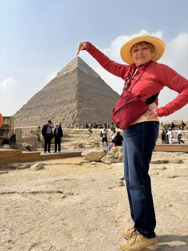 Nancy touching the top of the Great Pyramid, Giza plateau, Egypt