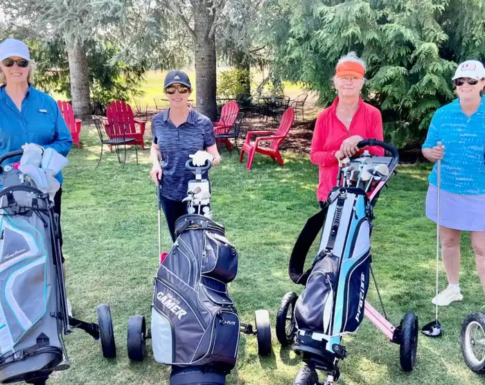 women with golf carts